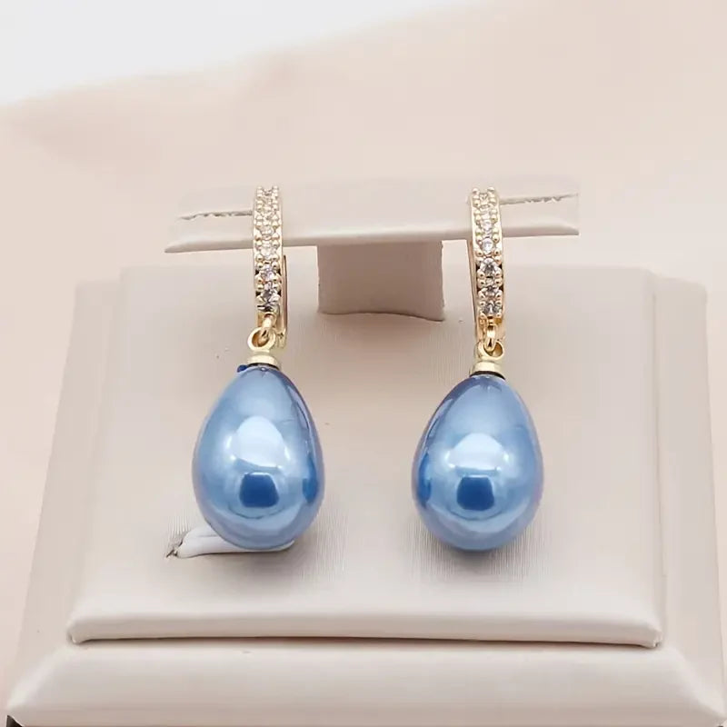 Oorbellen met blauwe oceaan-dauwmotief | Goud